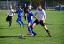 A Sporting Bengal United player looks to keep the ball from a Hoddesdon Town rival (pic: Tim Edwards).