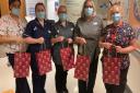 Staff with the gift bags full of treats for children in hospital