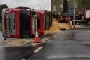 A lorry carrying sawdust overturned in Woodford Avenue early this morning causing road closures in the area since just after 6.30am.