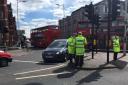 Police officers at the scene where a woman was hit by an unmarked police car in High Road, Ilford