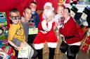 Father Christmas with children at the Haven House Christmas Party. Image: The Photo People