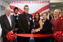 Luke Brook (centre) cutting the ribbon at Redbridge College's new Brook Centre with teachers and students.