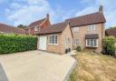 This detached, four bedroom house in Alconbury has a partially converted garage