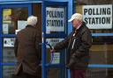 Voters arrive at a polling station