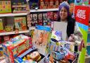 Kids Inc Nurseries employee, Sonia Sabharwal, shows off the bundle of toys which were donated to Queen's Hospital, King George Hospital and Redbridge Foodbank.