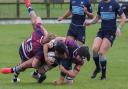 Eton Manor centre Aaron Lowe is tackled