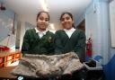 Shaheera Uddin, 10, and Muntaha Waqar, 10, from Highlands Primary School with a clay and wire trench created to mark the centenary of the First World War