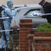 A forensic officer at the scene in Tavistock Gardens, Goodmayes