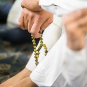 A worshipper holds pray beads ahead of the Eid prayer, which marks the end of Ramadan.