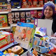 Kids Inc Nurseries employee, Sonia Sabharwal, shows off the bundle of toys which were donated to Queen's Hospital, King George Hospital and Redbridge Foodbank.