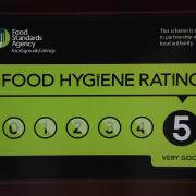 A Food Standards Agency rating sticker on a window of a restaurant in central London.