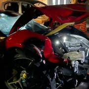A damaged red Ferrari, which was involved in the collision on Roman Road this morning.