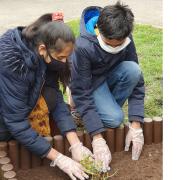 Head prefects at Barkingside's Fullwood Primary School planting on behalf of all its pupils.