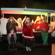 Father Christmas and his elves and helpers stop to meet excited children in Wanstead to raise money for five area schools.