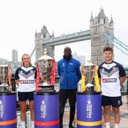 England Women\'s player Jodie Cunningham (left), rugby league legend Martin Offiah (centre) and England Wheelchair player Tom Halliwell (right) with the World Cup trophies near Tower Bridge to celebrate The National Lottery being the Official Partner of