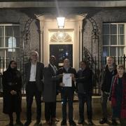 Campaigners including Andy Walker (second from left) with the letter outside 10 Downing Street
