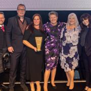 Members of Oakland Care receive their award from Investors in People chief executive Paul Devoy - left - and event host Anna Richardson - right
